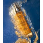 huile sèche pailletée corps et cheveux à base d'huile d'amande douce marque Exsens effet reflet doré pailleté flacon pompe en verre contenance 50ml